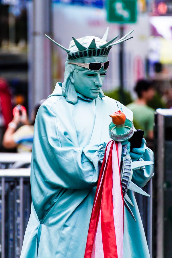 Voyage à New-York Manhattan - la Statue de la Liberté vérifie son smartphone